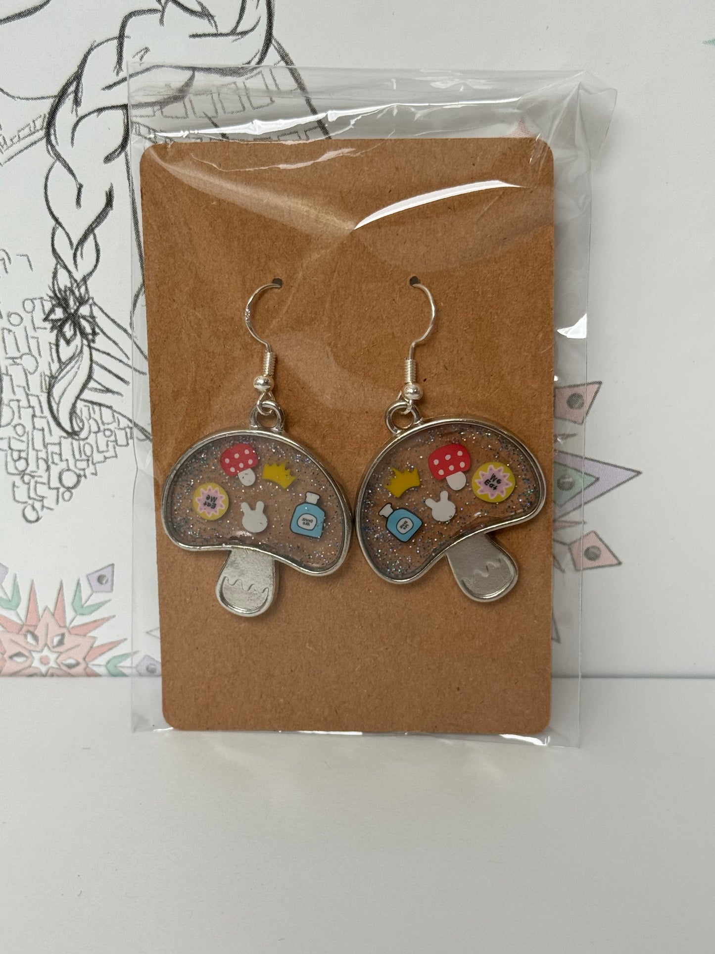 Mushroom-shaped with sprinkles featuring bunny, crown, eat me and drink me, and mushroom inspired by alice in wonderland earrings