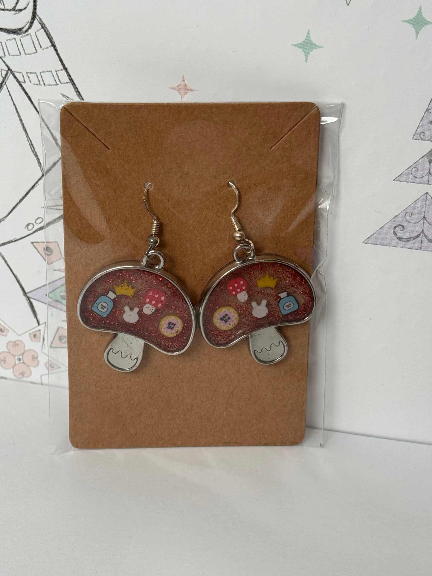 Mushroom-shaped with sprinkles featuring bunny, crown, eat me and drink me, and mushroom inspired by alice in wonderland earrings