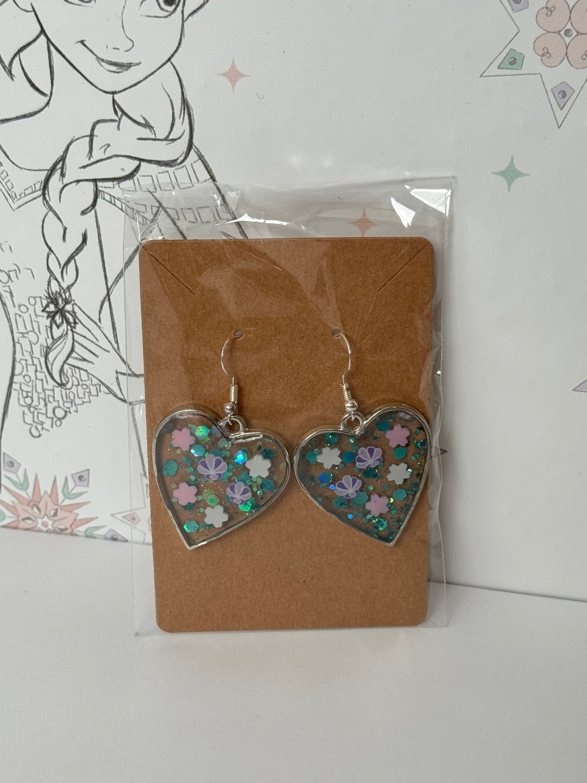 Heart-shaped earrings with sparkles and shells inspired by the one and only little mermaid red haired mermaid