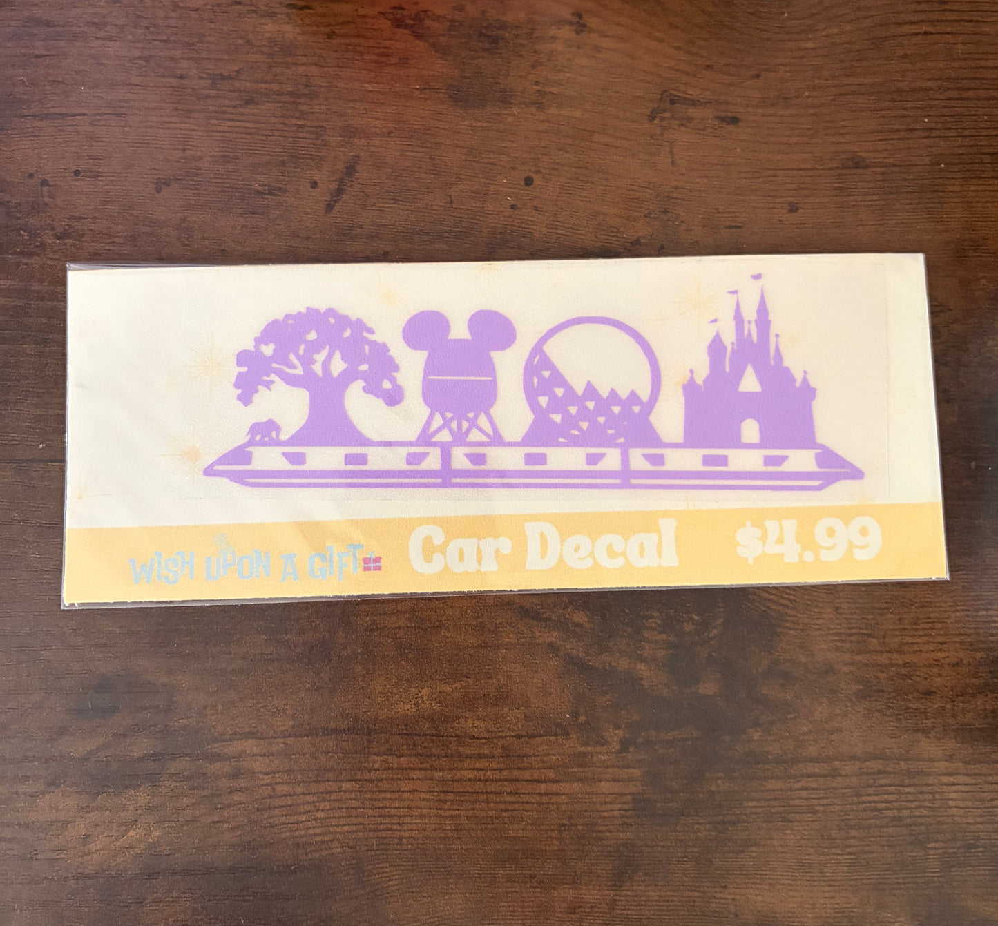 Car decal with Disney-themed design on a wooden surface