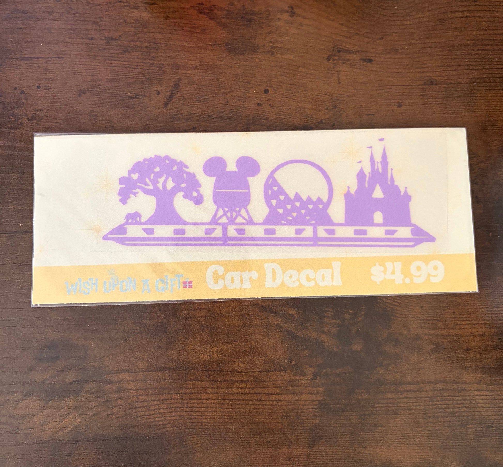 Car decal with Disney-themed design on a wooden surface