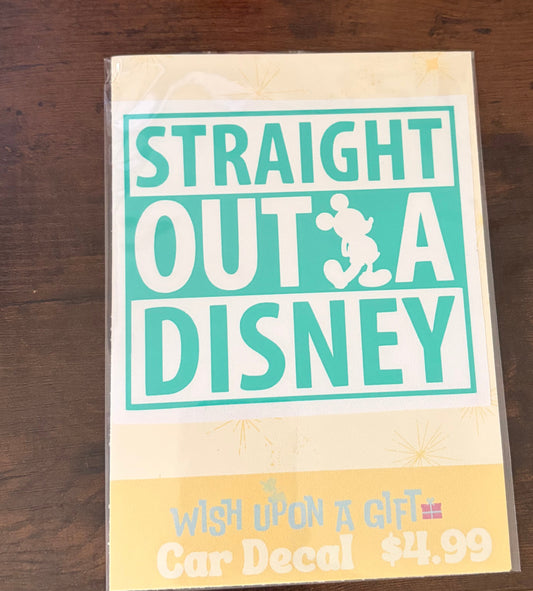 Product packaging with 'Straight Outta Disney' decal on a wooden surface.