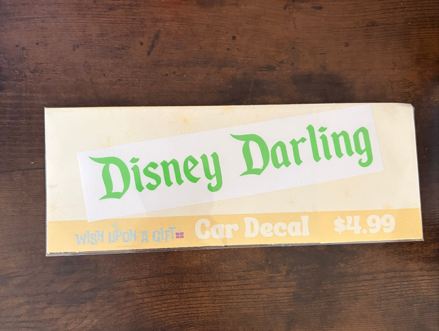 Car decal packaging with graphics of disney darling decal on a wooden surface