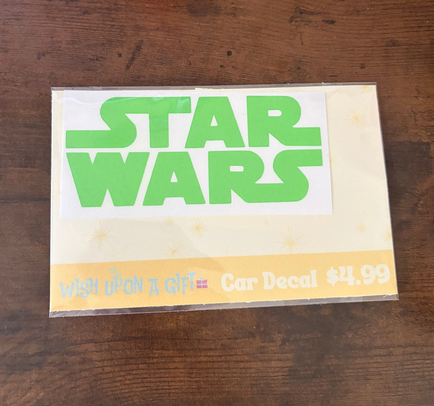 Car decal packaging with graphics of star wars logo on a wooden surface