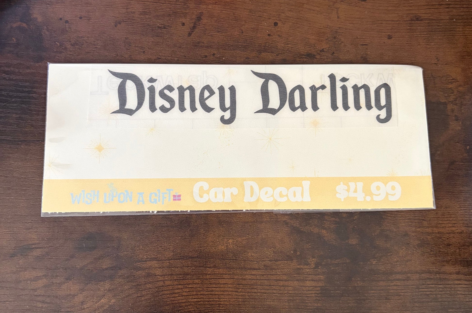 Car decal packaging with graphics of disney darling decal on a wooden surface