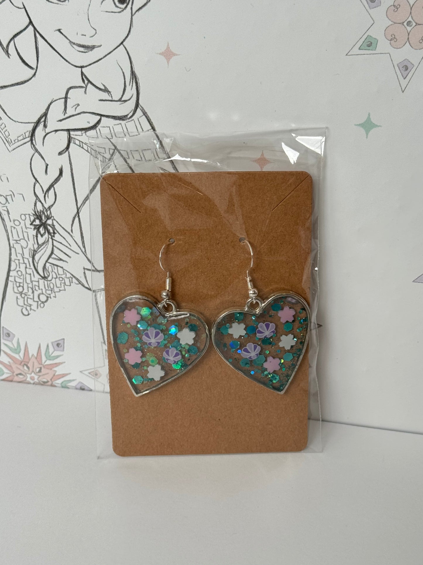 Heart-shaped earrings with sparkles and shells inspired by the one and only little mermaid red haired mermaid